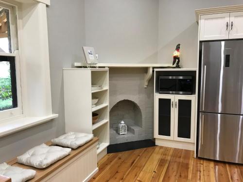 a kitchen with a refrigerator and a stove at Ambrosia Holiday Home in Tanunda