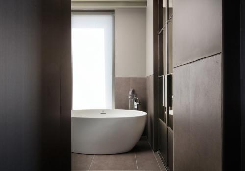 a bathroom with a white tub and a window at Park Marine Hotel in Incheon