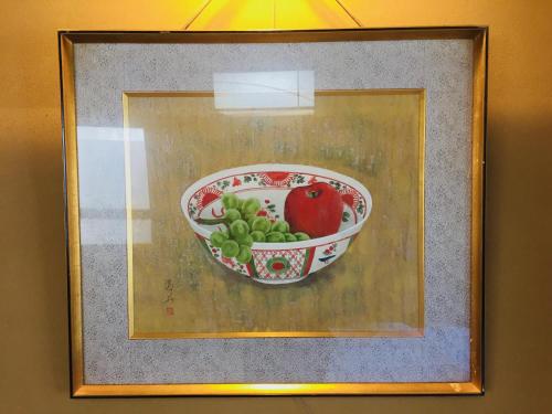 a painting of a bowl of fruit on a wall at Daymaruya Ryokan in Yamanouchi