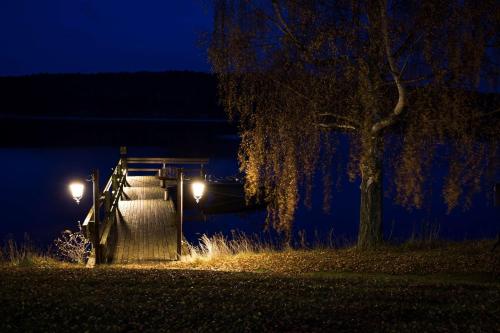 a nightime picture of a dam with a tree at Hotell Frykenstrand; Sure Hotel Collection by Best Western in Sunne