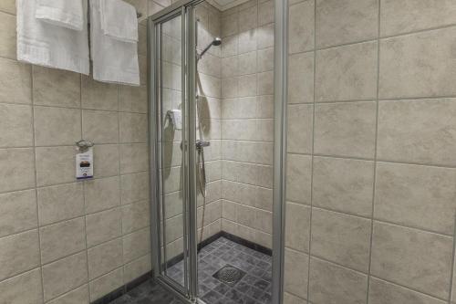 a shower with a glass door in a bathroom at Best Western Leto Arena in Dal