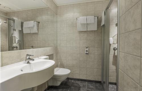 a bathroom with a sink and a toilet and a shower at Best Western Leto Arena in Dal