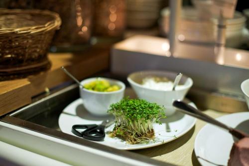 a counter with three bowls of food on plates at Best Western Hotel Baltic in Sundsvall