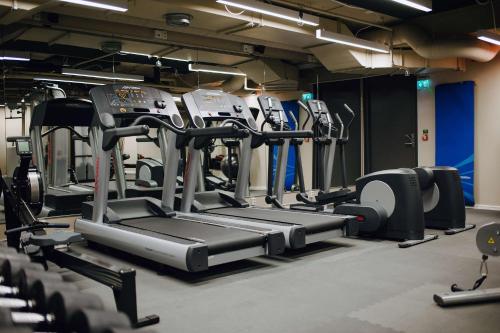a gym with several treadmills and machines at Best Western and hotel in Stockholm