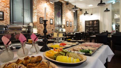 a buffet of food on a table in a restaurant at Best Western Hotel Herman Bang in Frederikshavn