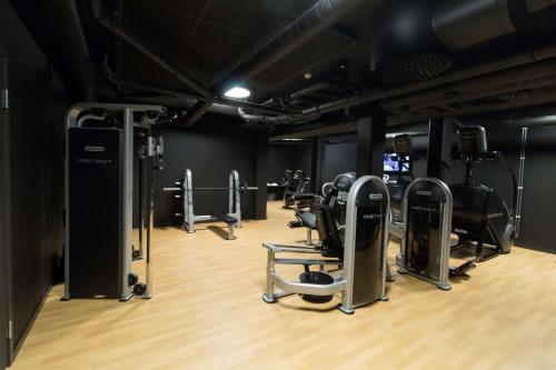 a gym with treadmills and cardio equipment in it at Best Western Plus Hus 57 in Ängelholm