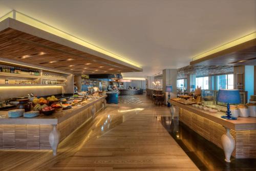a restaurant with a buffet line in a building at Hyatt Regency Ludhiana in Ludhiana
