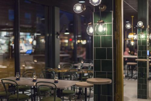 a row of tables and chairs in a restaurant at Best Western Plus Hus 57 in Ängelholm