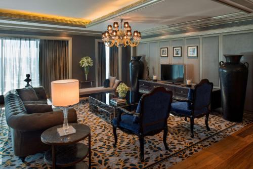 a living room with a couch and a piano at Hyatt Regency Ludhiana in Ludhiana
