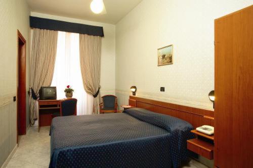 a bedroom with a blue bed and a television at Hotel Demetra Capitolina in Rome