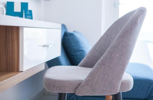 a pair of chairs in front of a desk at The Blue Ivy Hotel & Suites in Protaras