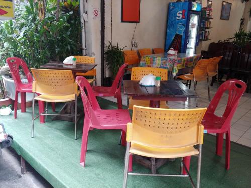 a group of tables and chairs at a restaurant at Prasuri Guest House in Bangkok