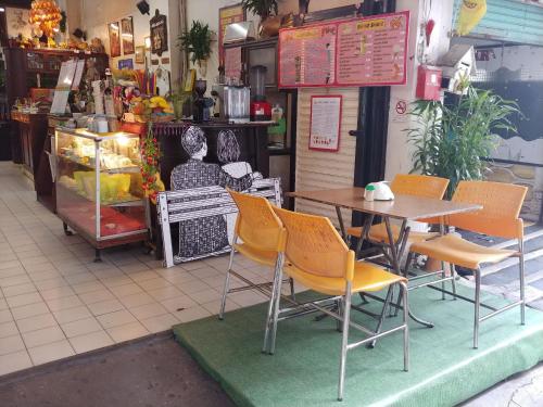 a table and chairs in front of a restaurant at Prasuri Guest House in Bangkok