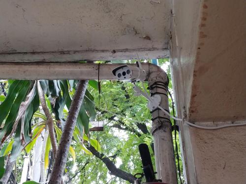 a mask hanging from the ceiling of a building at Prasuri Guest House in Bangkok