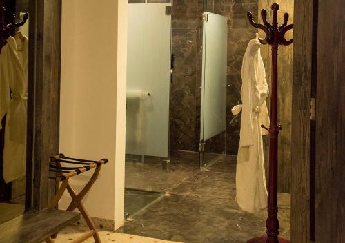 a bathroom with a robe hanging on a pole at Regenta Central Hotel & Convention Centre Nagpur in Nagpur