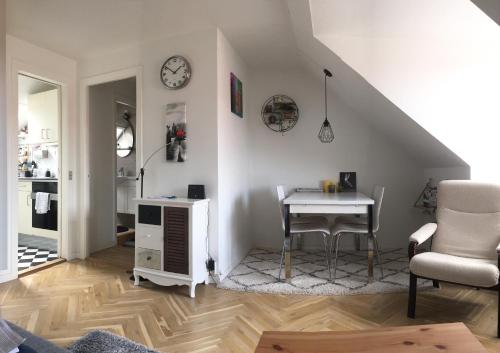 a living room with a table and a chair at Borups Allé 249 in Copenhagen