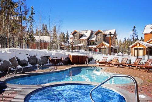 a swimming pool in a yard with chairs and a house at 6532 Settlers Creek Condo in Keystone
