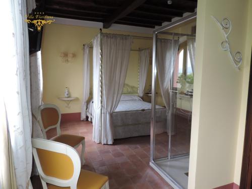 a bedroom with a canopy bed in a room at Villa Floridiana in Anagni