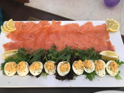 a plate of food with eggs and a piece of fish at Berghotel-Willingen in Willingen
