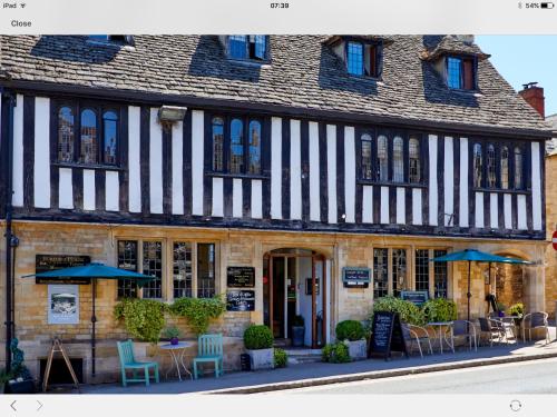 a restaurant with a large window on the side of the building at Burford House in Burford