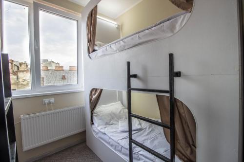 two bunk beds in a room with a window at hi Hostel in Lviv
