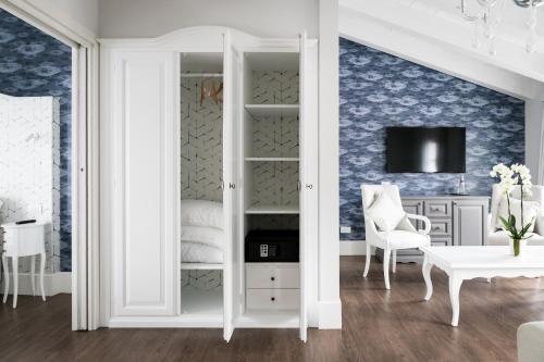 a room with a white closet with a table and a chair at Belvedere in Stresa