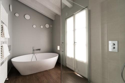 a bath tub in a bathroom with a glass door at Belvedere in Stresa