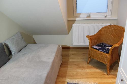 1 dormitorio con 1 cama, 1 silla y 1 ventana en Befeld Susanne, en Neustadt in Holstein