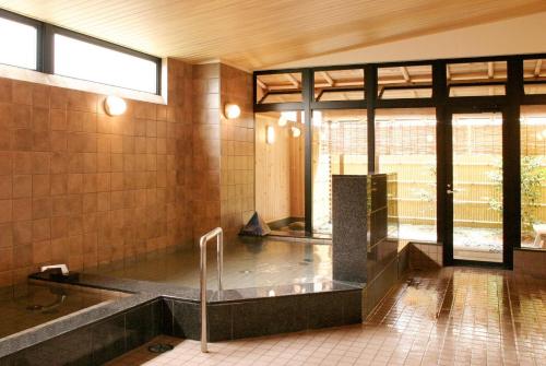 a bathroom with a bath tub in a building at New Commander Hotel Osaka Neyagawa / Vacation STAY 1341 in Neyagawa