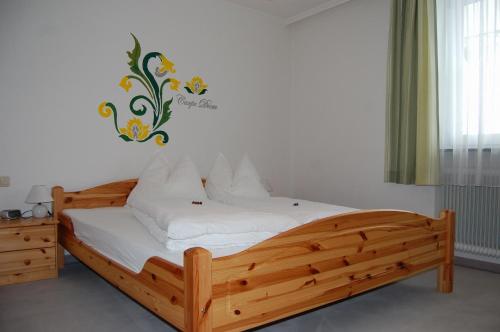 a wooden bed in a room with a sign on the wall at Haus Lechner Apartments in Sankt Jakob in Haus