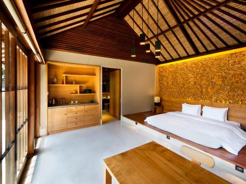 A bed or beds in a room at Hoshinoya Bali