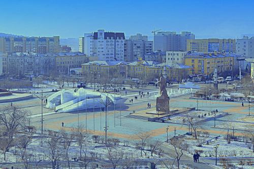 a park with a statue in the middle of a city at Hotel Zabaykalie in Chita