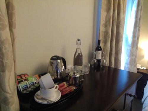 a table with a tray of food and a bottle of wine at The Kings Head Hotel in Ross on Wye