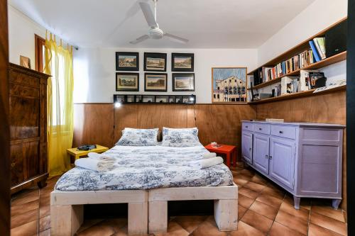 a bedroom with a bed and a desk and shelves at Cà Tolentini in Venice