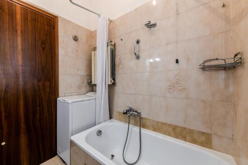 a bathroom with a tub and a toilet and a shower at Cà Tolentini in Venice