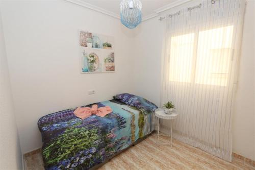 una camera da letto con un letto con un arco sopra di La Mata Apartment 5080 a La Mata