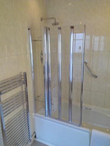 a bathroom with a shower and a bathtub with a shower at The Kings Head Hotel in Ross on Wye