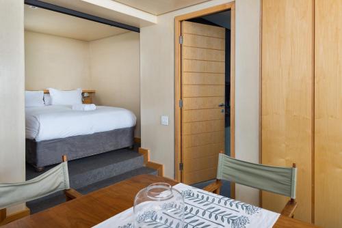 a room with a bed and a table and chairs at Glencoe 40 in Cape Town