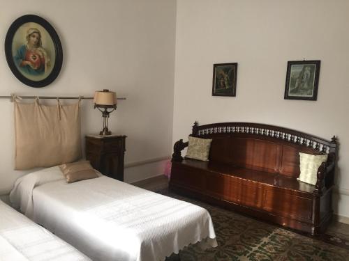 a bedroom with two beds and a headboard at Guesthouse City Center in Bari