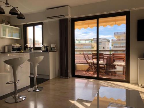 a kitchen with a view of a balcony with a table at Appartement Residence Athena in Cannes