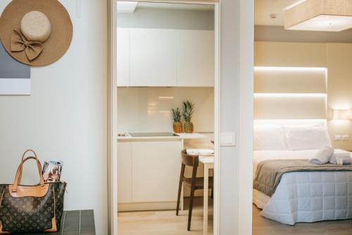 a bedroom with a bed and a table with a hat at Aparthotel Touring in Grado
