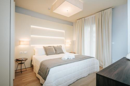 Ένα ή περισσότερα κρεβάτια σε δωμάτιο στο Aparthotel Touring