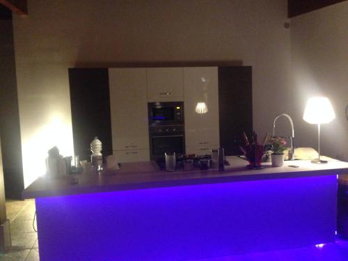 a kitchen with a purple counter top in a room at Beach Club Ippocampo in Ippocampo