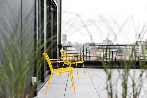 two yellow chairs sitting on top of a building at Upstairs Hotel in Ostend