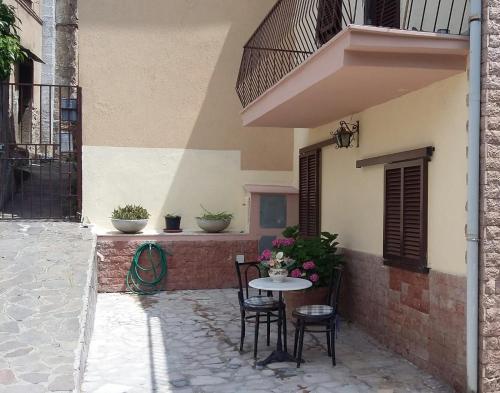 a patio with a table and chairs next to a building at Casa Swami in La Spezia