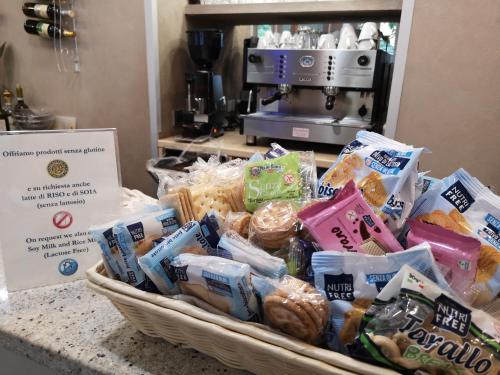 a basket filled with different types of food on a counter at Hotel Piacenza in Milan