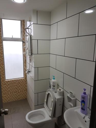a bathroom with a toilet and a sink at Taiping Centre Point Suite 9 by BWC in Taiping