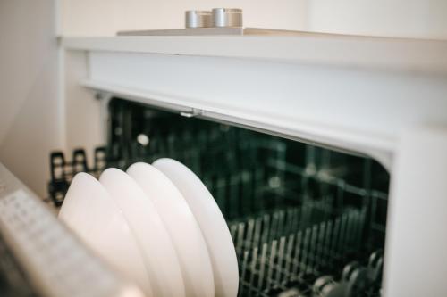 a microwave oven with its door open in a kitchen at Aparthotel Touring in Grado