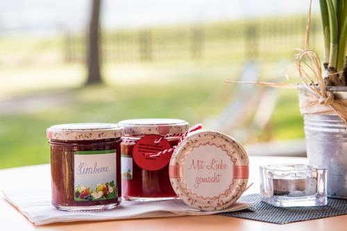 two jars of jam sitting on top of a table at JUFA Hotel Maria Lankowitz in Maria Lankowitz