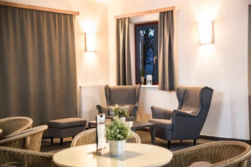 a waiting room with chairs and a table at JUFA Hotel Maria Lankowitz in Maria Lankowitz